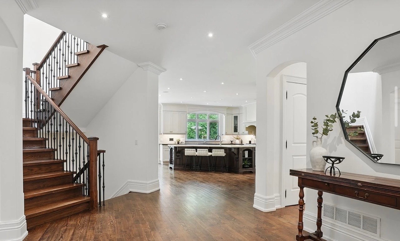 Staircase and open-concept kitchen with clean, even walls